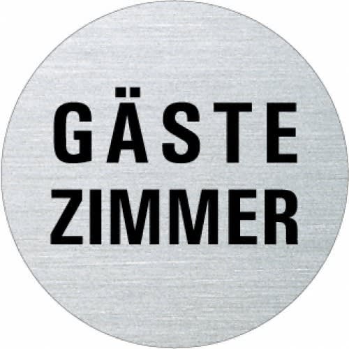 Rundes Metallschild mit der Aufschrift Gästezimmer in schwarzer Schrift