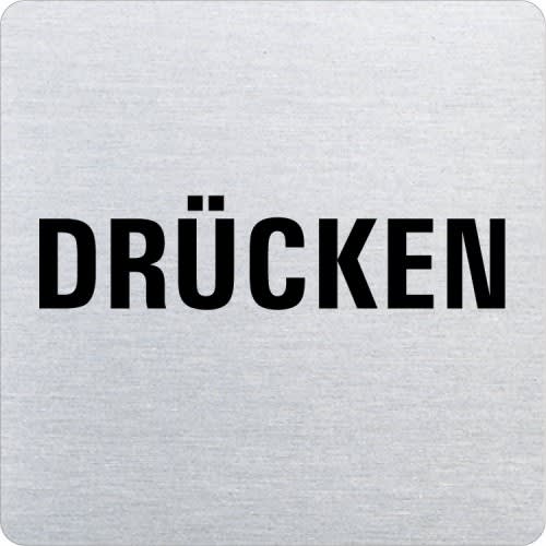 Metallschild mit abgerundeten Ecken und dem schwarzen Schriftzug Drücken auf silbernem Hintergrund