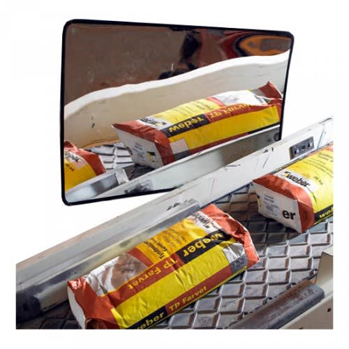 Industriespiegel CHECK MIRROR mit reflektierender Oberfläche, zeigt Baustoffe und Werkzeuge auf einem Gitterrost