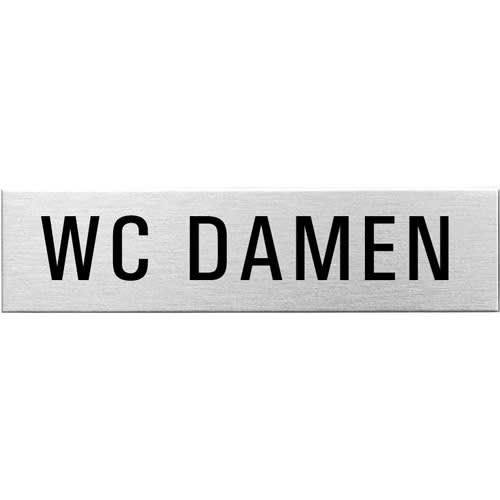 Eckiges Textschild mit der Aufschrift WC Damen in schwarzer Schrift auf silbernem Hintergrund