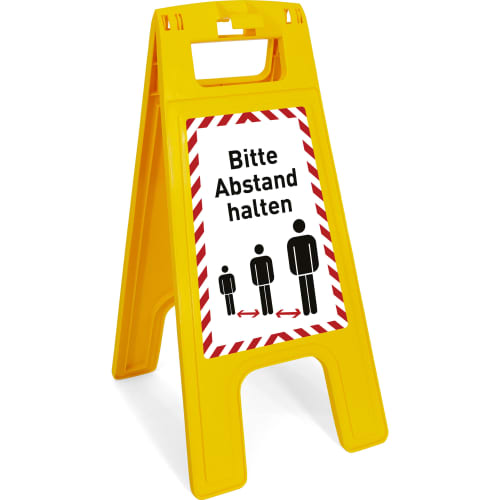 Gelber Warnaufsteller mit dem Hinweis Bitte Abstand halten und Symbolen von drei Personen mit Abstand