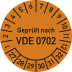 Prüfplakette orange mit Aufschrift Geprüft nach VDE 0702 und Zahlenring von 1 bis 12 und 27 bis 32