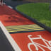 Temposchwelle TOPSTOP auf rotem Fahrradweg mit gelben Streifen und weißem Fahrradsymbol