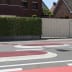 Fahrbahnschwelle Berliner Kissen GAMMA oval in rot und weiß auf einer Straße vor Wohnhäusern