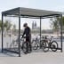 Fahrradüberdachung Köln Bike Economy K3 b/b mit mehreren Fahrrädern und Person mit Helm