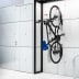 Fahrradaufhängung Bike Lift mit Wandschutz für Hinterrad an moderner Betonwand mit aufgehängtem Fahrrad