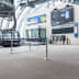 Gurtabsperrpfosten Beltrac Extend Double mit schwarzen Absperrbändern in einer modernen Seilbahnstation
