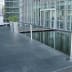 Gurtabsperrpfosten Beltrac Modern aus Edelstahl mit schwarzem Gurt in moderner Architekturumgebung
