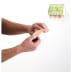 PLUM Pflasterspender QuickFix UNO an der Wand mit ausgestreckten Händen, die ein Pflaster entnehmen